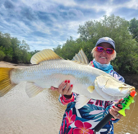 Lorraine Golightly with a barramundi caught on a Panic Station Mullet Guns & Roses lure in Cairns